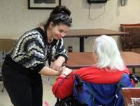 Alexa Bucci, a friendly, high-spirited volunteer, chats with a resident of St. Monica Manor, an archdiocesan skilled nursing facility in South Philadelphia. (Sarah Webb)