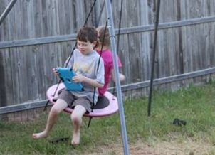 Danielle and Duane's son Harrison and 7-year-old daughter Libby play in the backyard of their Yukon home. Photo by Clifton Adcock, Oklahoma Watch