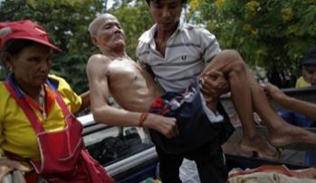 A disabled man evacuated from flooded area is brought to a collective shelter in Pathum Thani province, Thailand, Oct. 12, 2011. REUTERS/Damir Sagolj