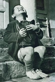 Austrian boy receives new shoes during WWII