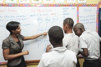 Triesha-Gaye McBean (left) doing interactive reading lessons with some of the children in her class at the Windsor School of Special Education.
