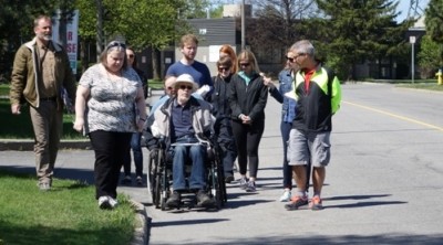Ginette Trottier of Parkinson Canada and Jerry Fiori of the Ottawa Disability Coalition are joined by Keith Egli (right), the councillor for Knoxdale–Merivale and chair of Ottawa's Transportation Committee, during a safety audit Wednesday morning.