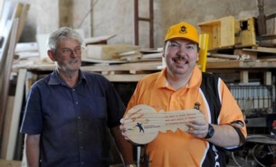 PROUD: Rodney Fisher and woodwork tutor Wayne Morris with the wooden key that will be presented to City of Greater Bendigo. Picture: JODIE DONNELLAN
