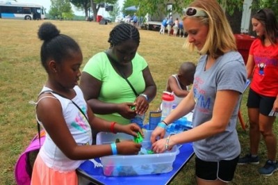 Keymari Swain, 9, left, and her aunt Elisha Pratcher play with Kinetic Sand as Jessica Silk from We Rock the Spectrum kids gym helps them out at the Disability Pride Celebration on Sunday in Delaware Park to mark the 26th anniversary of Americans wit