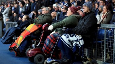 Disabled supporters attend a football match. Credit: PA