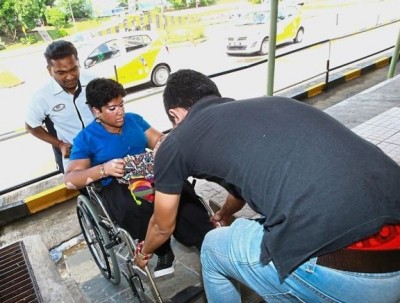 Aveena getting help to lift her wheelchair in the absence of a ramp. Most theory examination locations in Malaysia are not disabled-friendly.   Read more at http://www.thestar.com.my/metro/community/2017/06/19/disabled-learner-drivers-cry-for-help-th